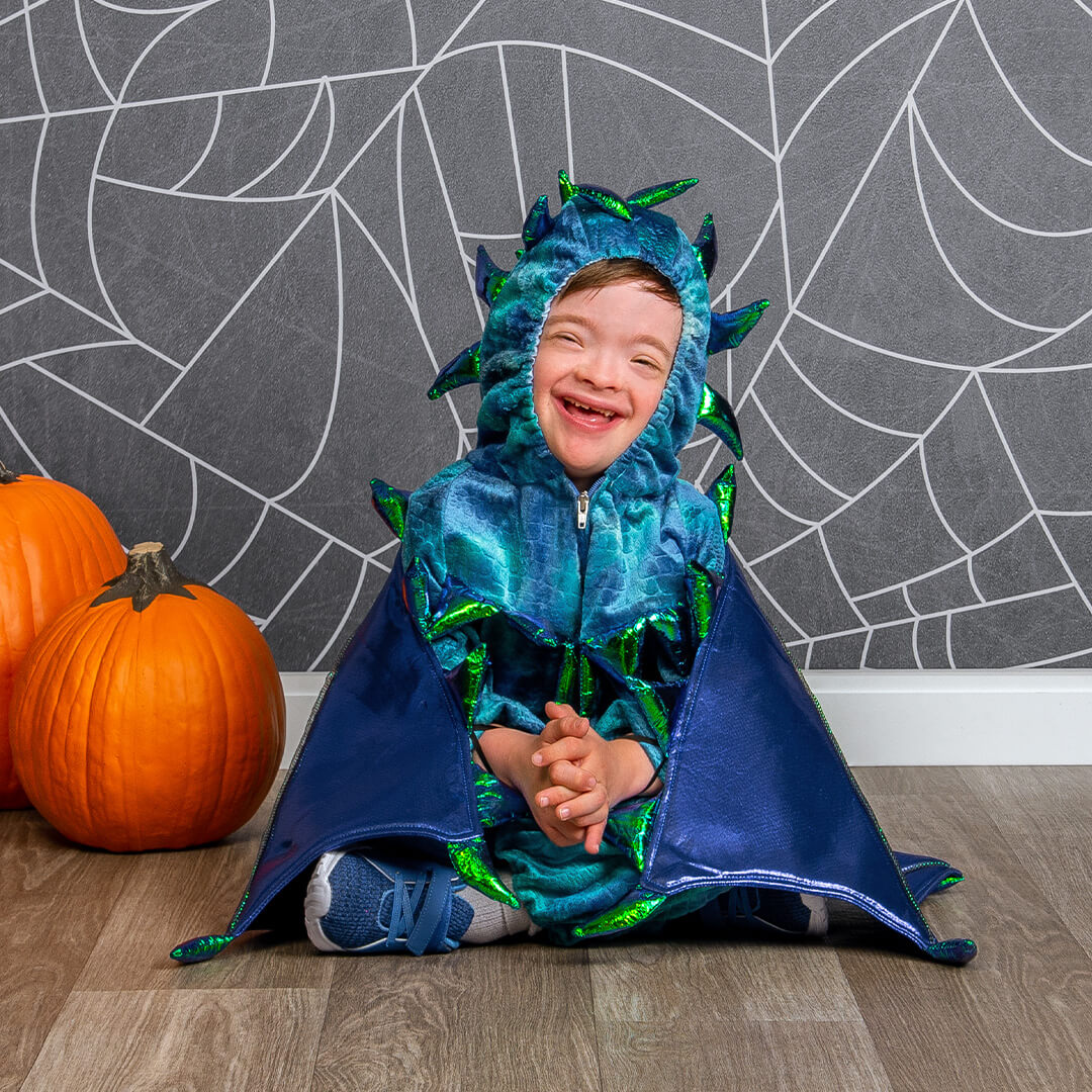 Boy in a dinosaur costume for kids Halloween pictures at JCPenney Portraits.