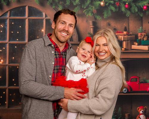 Family photographed on new holiday background, Santa's Toy Shop