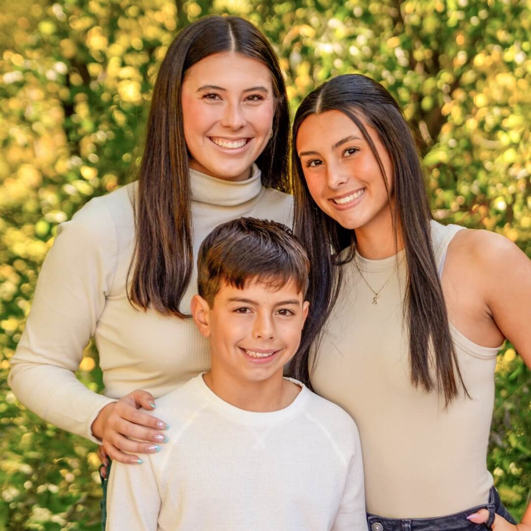 3 siblings posing for outdoor photos at JCPenney Portraits.