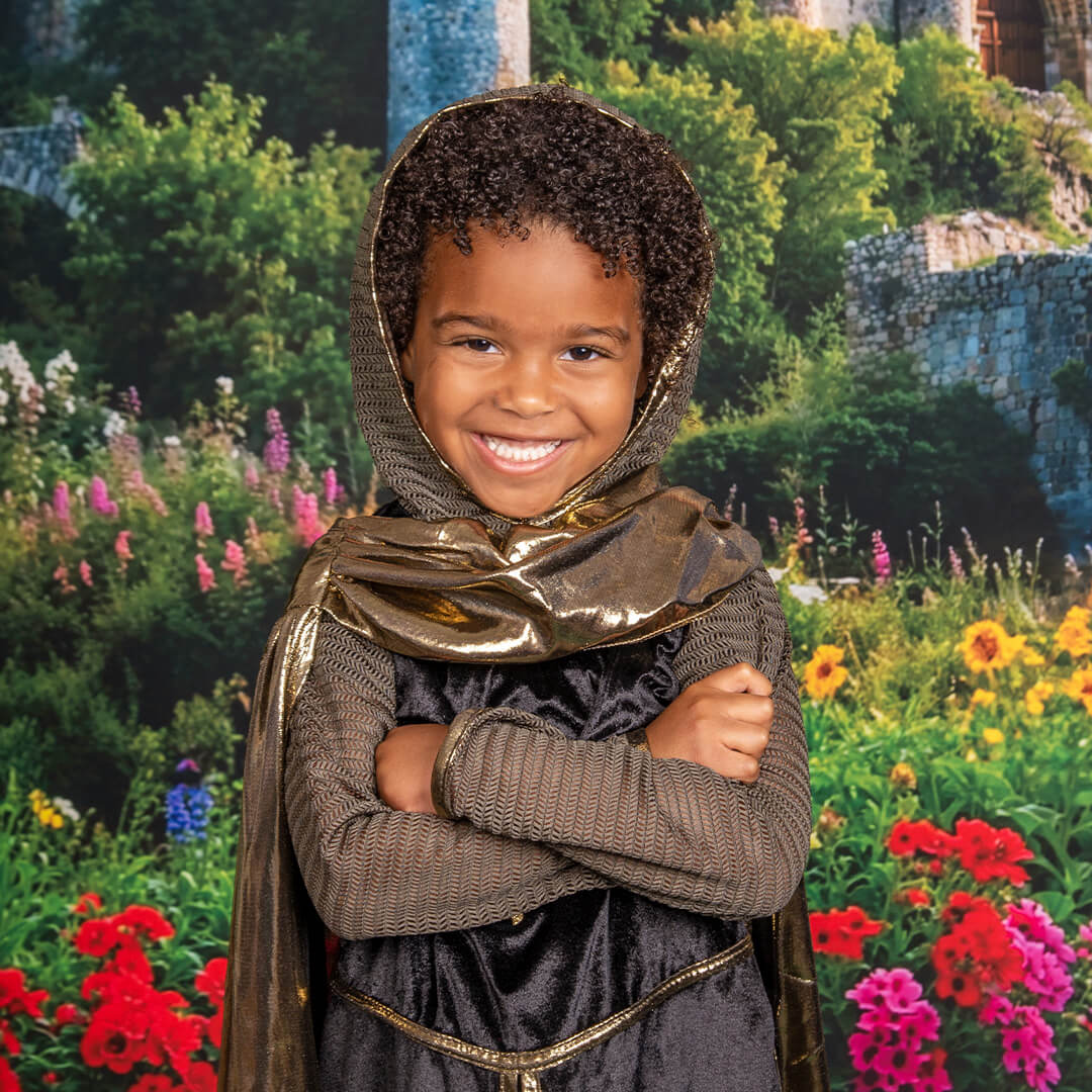 Boy in a knights costume posing for Enchanted Kingdom photos.