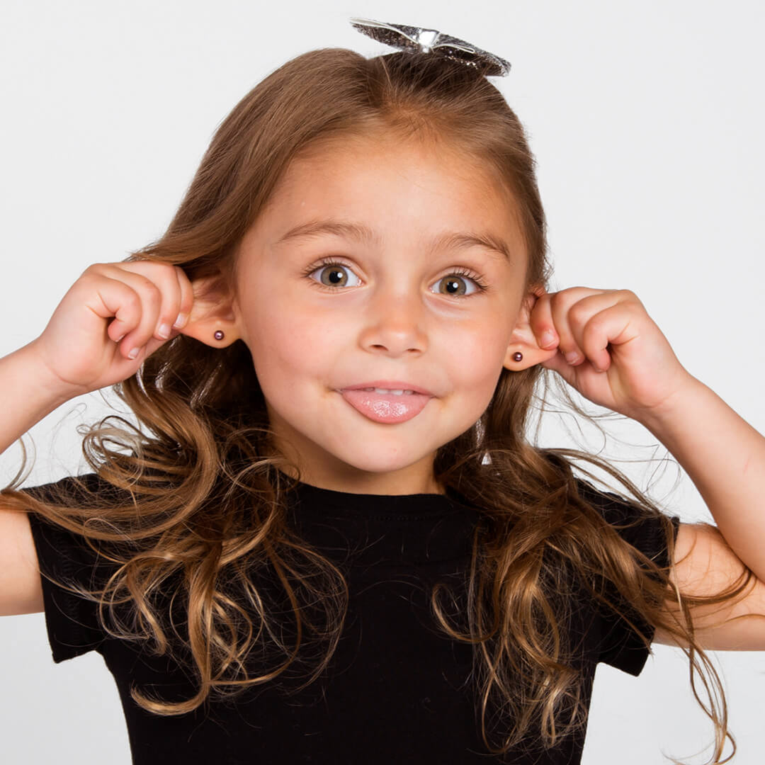 Young girl posing for candid photos on a white background.