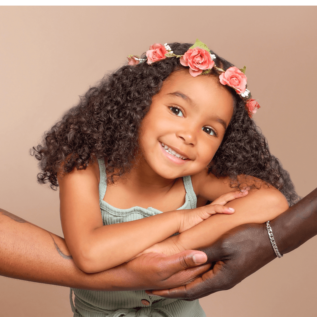 Girl wearing a flower crown posing for pictures at JCPenney Portraits.