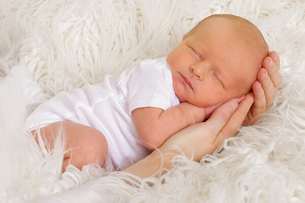 Newborn photographed on a blanket.