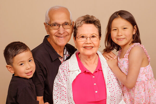 Photo of grandchildren and their grandparents for grandparent photography at JCPenney Portraits.