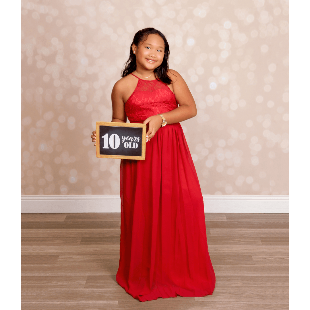 Girl in a red dress for 10th birthday photos at JCPenney Portraits.