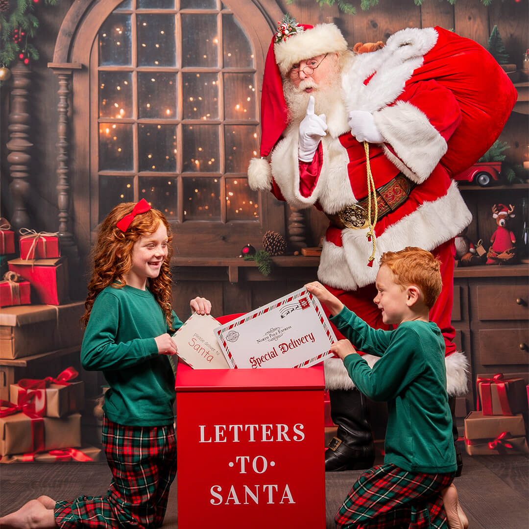 Siblings opening letters to Santa.