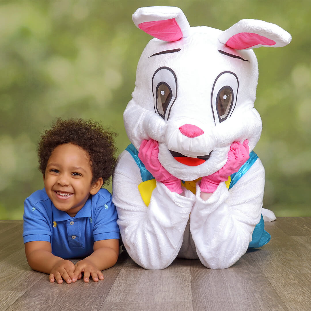 A boy taking pictures with the Easter Bunny at JCPenney Portraits.