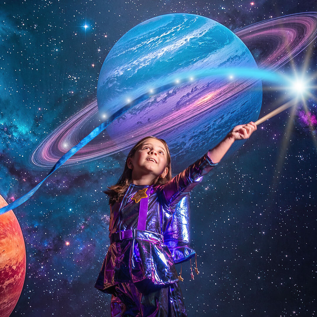 Girl in an astronaut costume photographed for space photos.