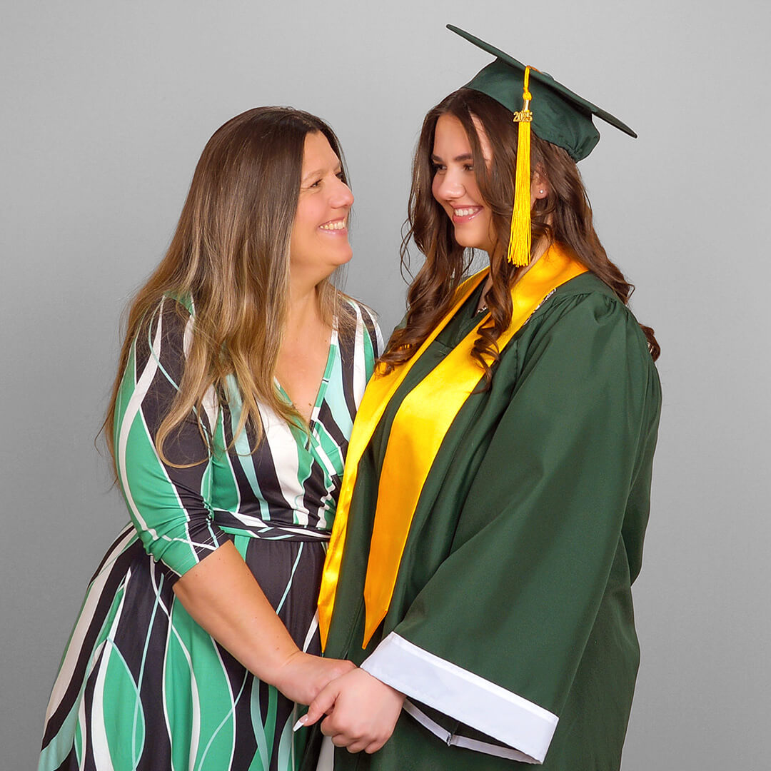 Graduating senior and her mom posing for graduation pictures.