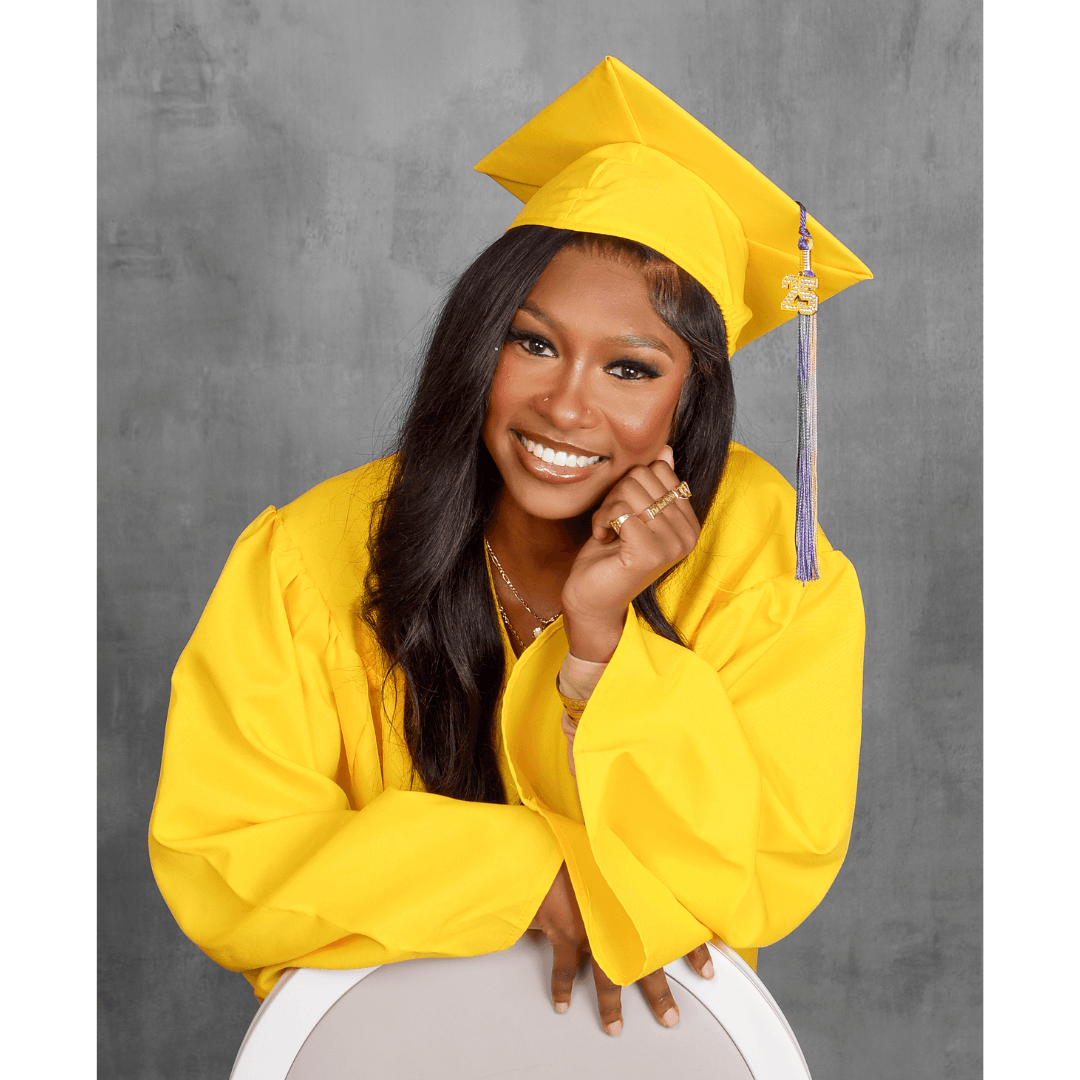 Woman in a yellow cap and gown for professional graduation photos.