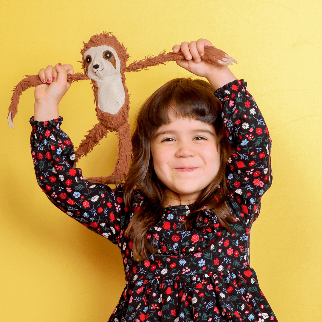 Girl holding a monkey prop for candid photos.