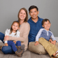 Family of four in coordinating outfits for professional family photos.