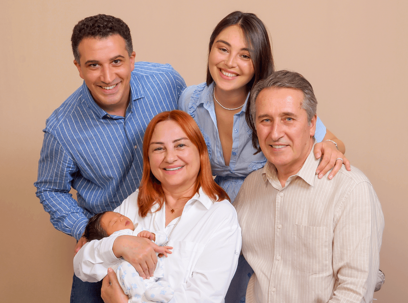 Family of five with a newborn, taking professional family pictures at JCPenney Portraits.