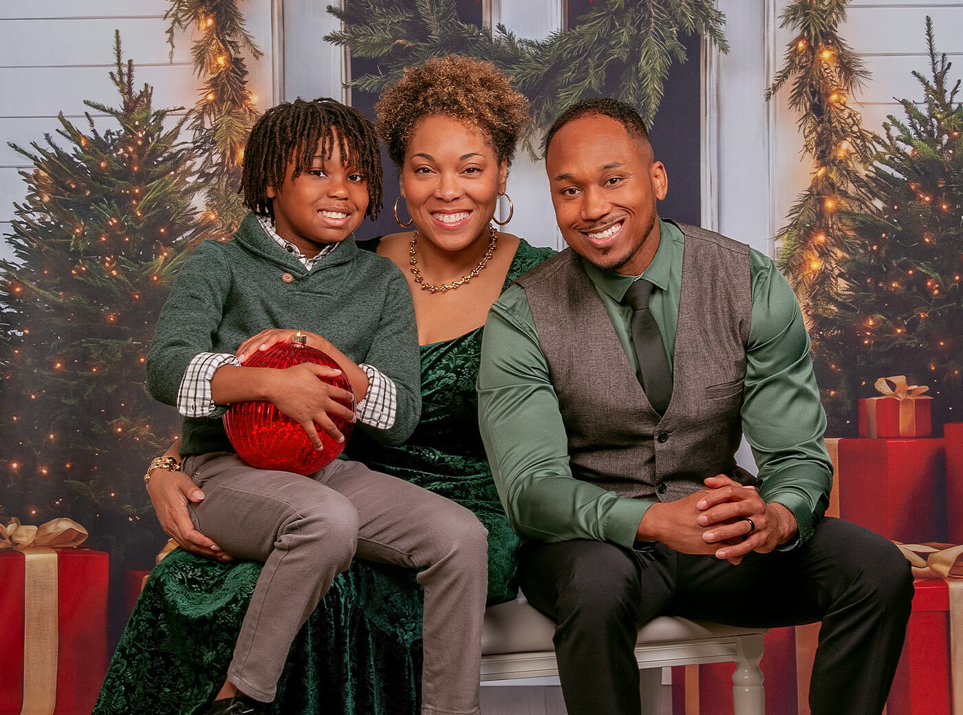 Family photographed on the new Evergreen Entry background for Christmas family photos at JCPenney Portraits.